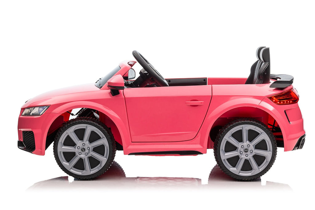 Kids ride one electric car in Pink
